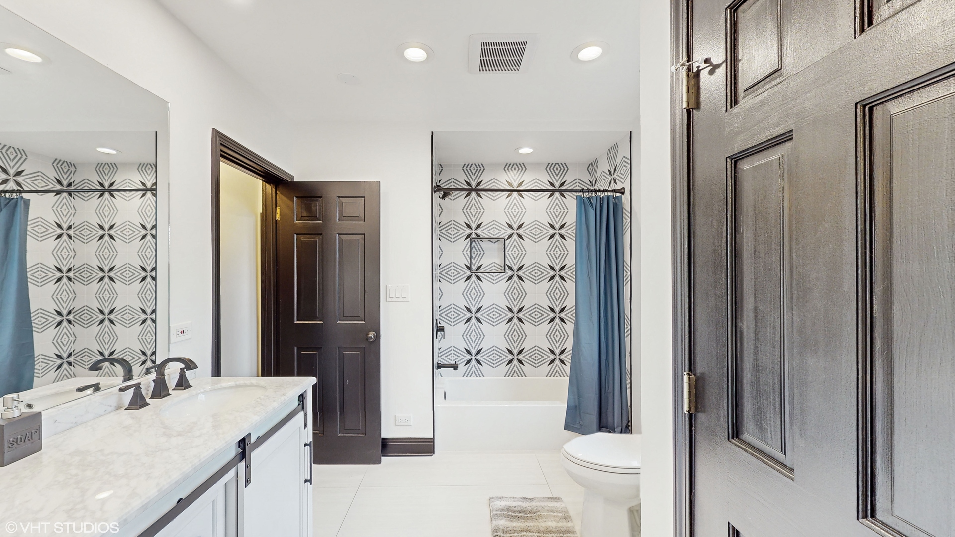 15160 West Oak Spring Road Libertyville, IL 60048 - Photo 21 of 36 a bathroom with a sink a toilet and shower