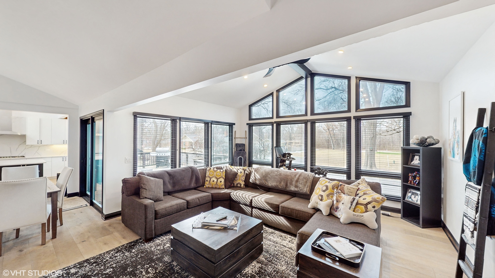 15160 West Oak Spring Road Libertyville, IL 60048 - Photo 6 of 36 a living room with furniture a rug a large window and a flat screen tv
