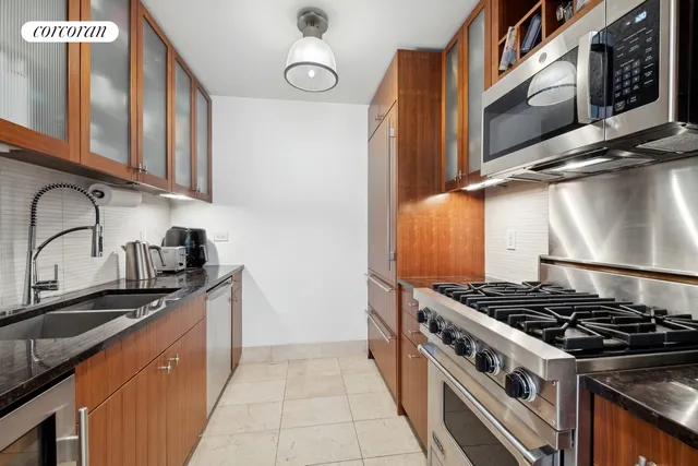 a kitchen with stainless steel appliances granite countertop a stove and a sink