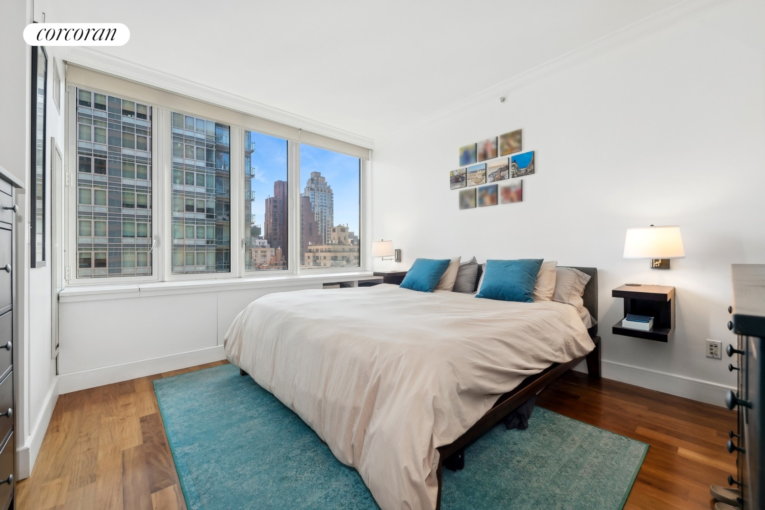 250 East 53rd Street, Unit 1403 Manhattan, NY 10022 - Photo 4 of 10 a bedroom with a large bed and a large window