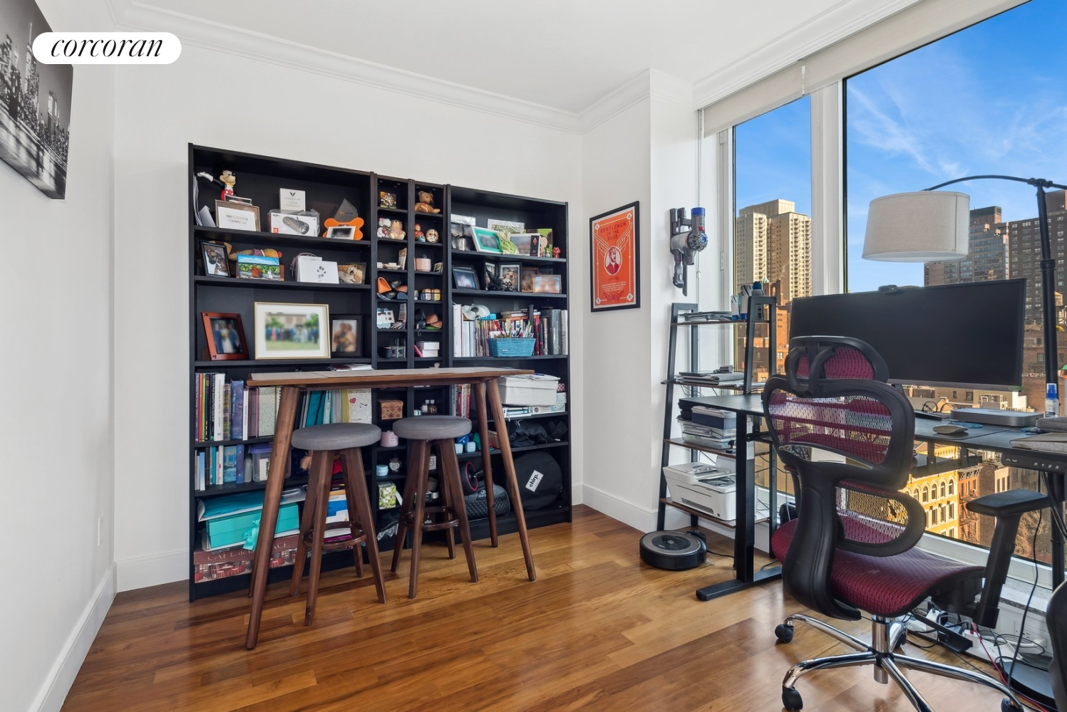 250 East 53rd Street, Unit 1403 Manhattan, NY 10022 - Photo 6 of 10 a view of a workspace with furniture and wooden floor