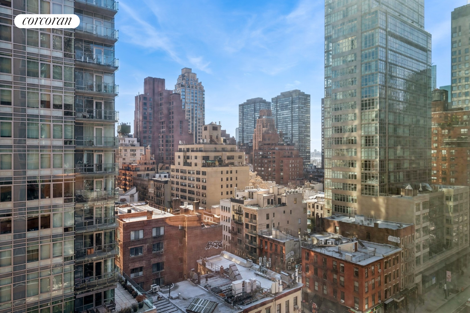 250 East 53rd Street, Unit 1403 Manhattan, NY 10022 - Photo 8 of 10 a city view with tall buildings