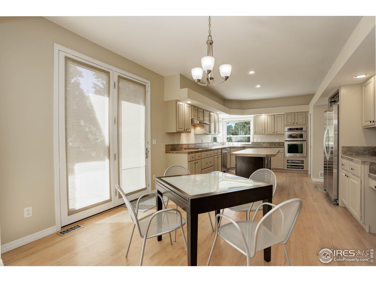 7346 Augusta Drive Boulder, CO 80301 - Photo 13 of 40 a view of a dining room with furniture and a large window