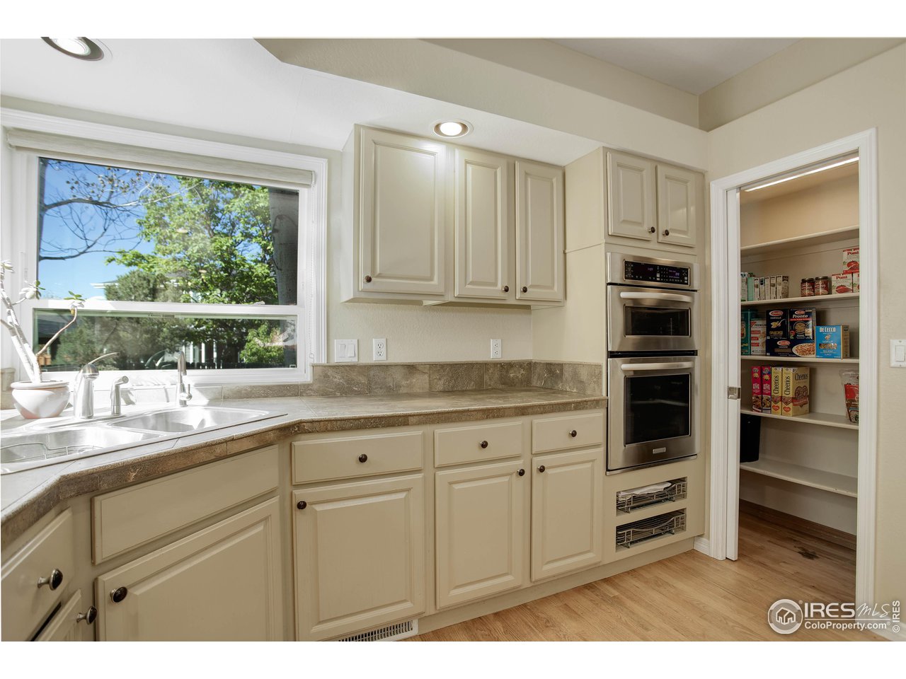7346 Augusta Drive Boulder, CO 80301 - Photo 15 of 40 a kitchen with stainless steel appliances white cabinets and a window
