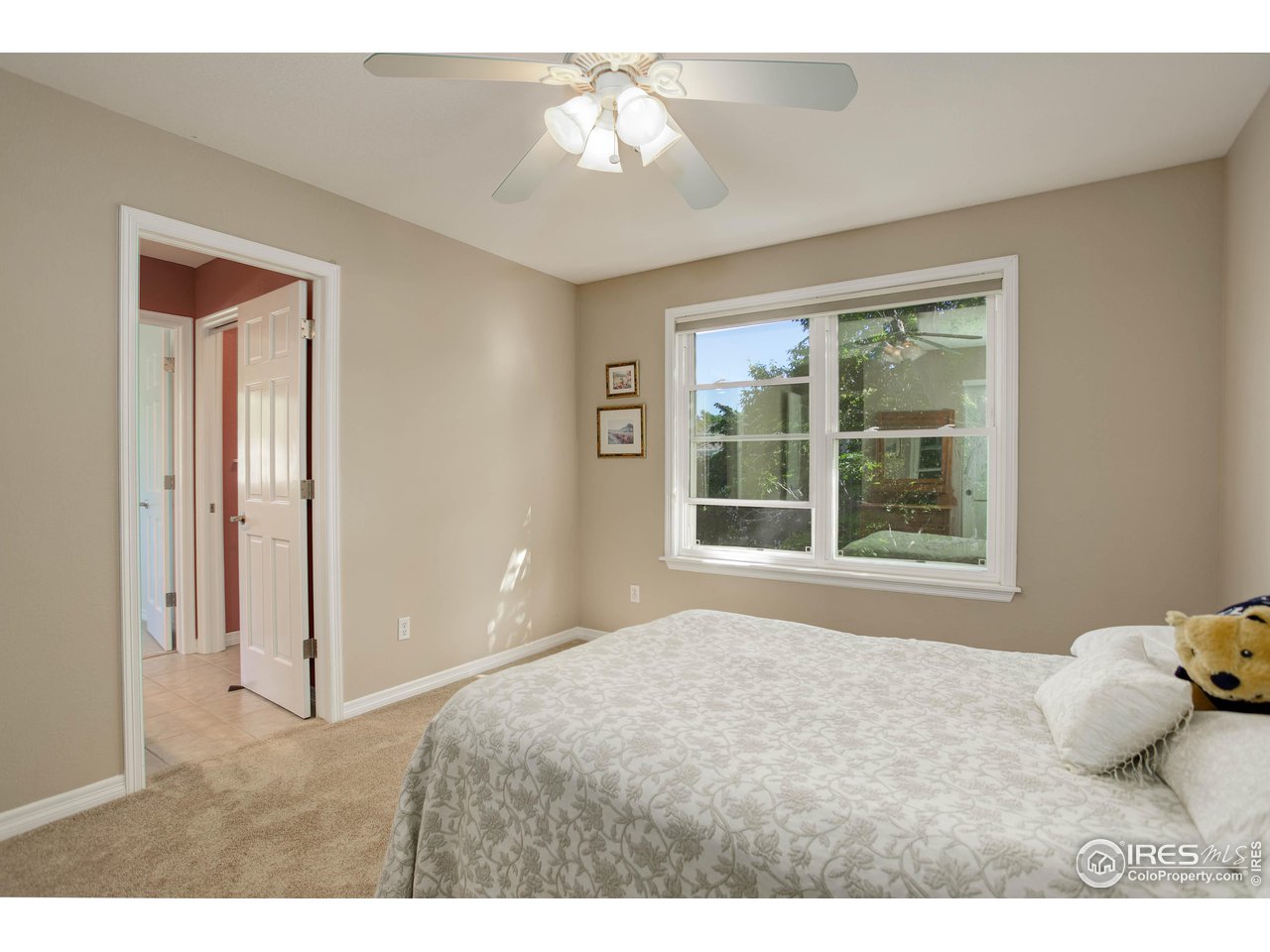 7346 Augusta Drive Boulder, CO 80301 - Photo 29 of 40 a bedroom with a bed and a chandelier