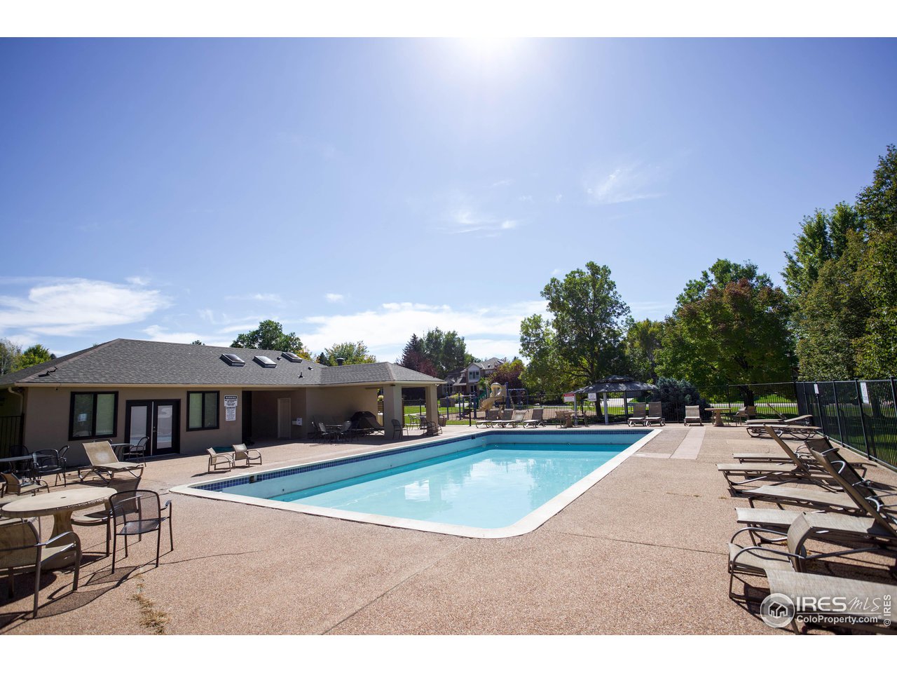 7346 Augusta Drive Boulder, CO 80301 - Photo 37 of 40 a view of a swimming pool with lawn chairs with plants
