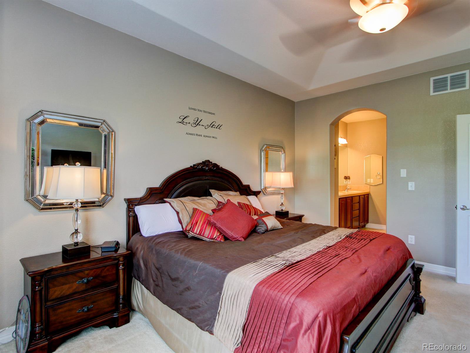 10186 RidgeGate Circle Lone Tree, CO 80124 - Photo 13 of 24 a bedroom with a bed and a lamp on dresser