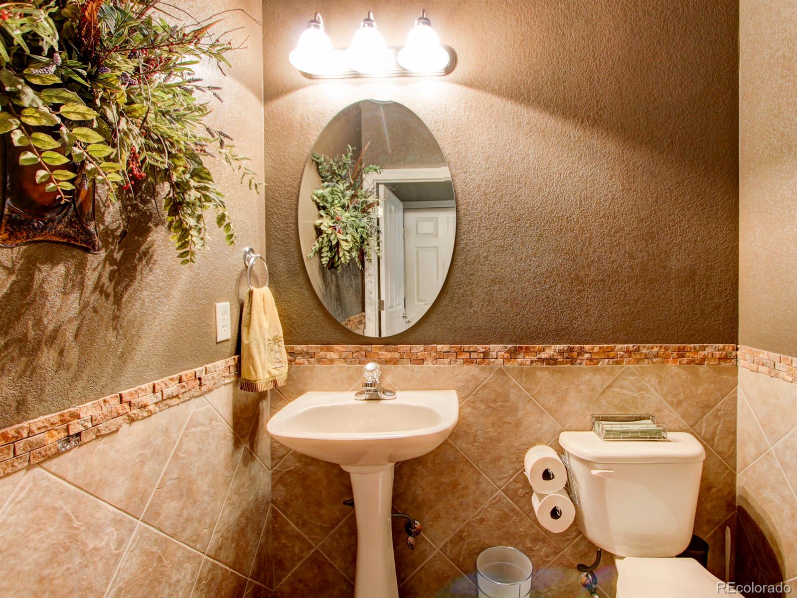 10186 RidgeGate Circle Lone Tree, CO 80124 - Photo 22 of 24 a bathroom with a toilet sink and mirror