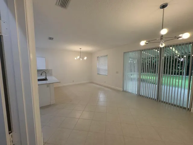 a view of a hallway with a sink and a window