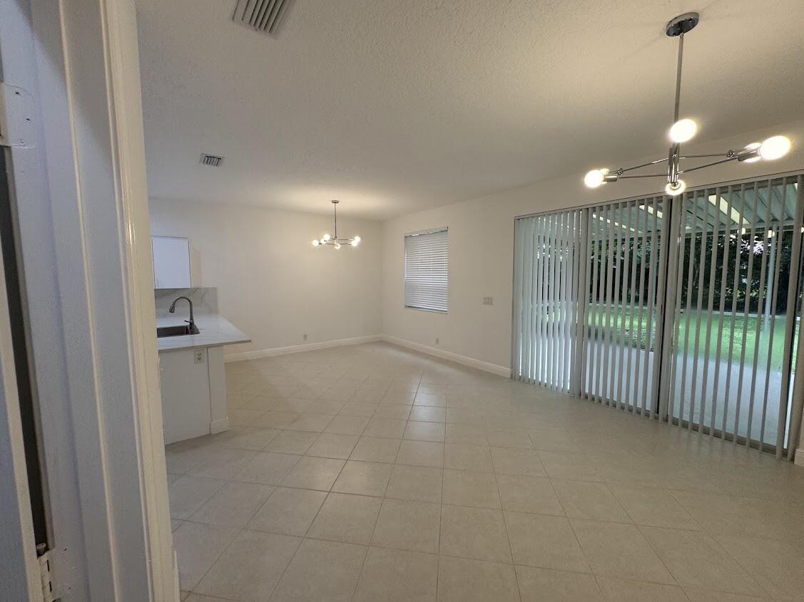 18237 Boca Way Drive Boca Raton, FL 33498 - Photo 13 of 36 a view of a hallway with a sink and a window