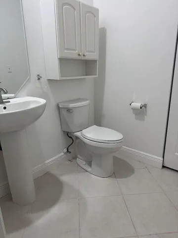 a bathroom with a sink a toilet and vanity