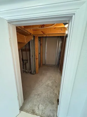 a view of a hallway with wooden walls