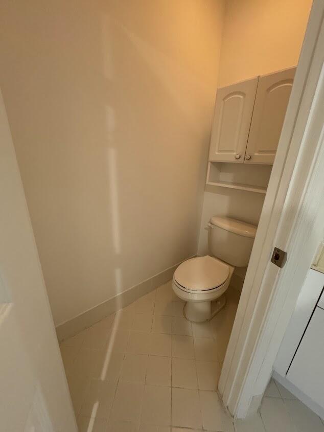 18237 Boca Way Drive Boca Raton, FL 33498 - Photo 18 of 36 a white toilet sitting next to a small white wall