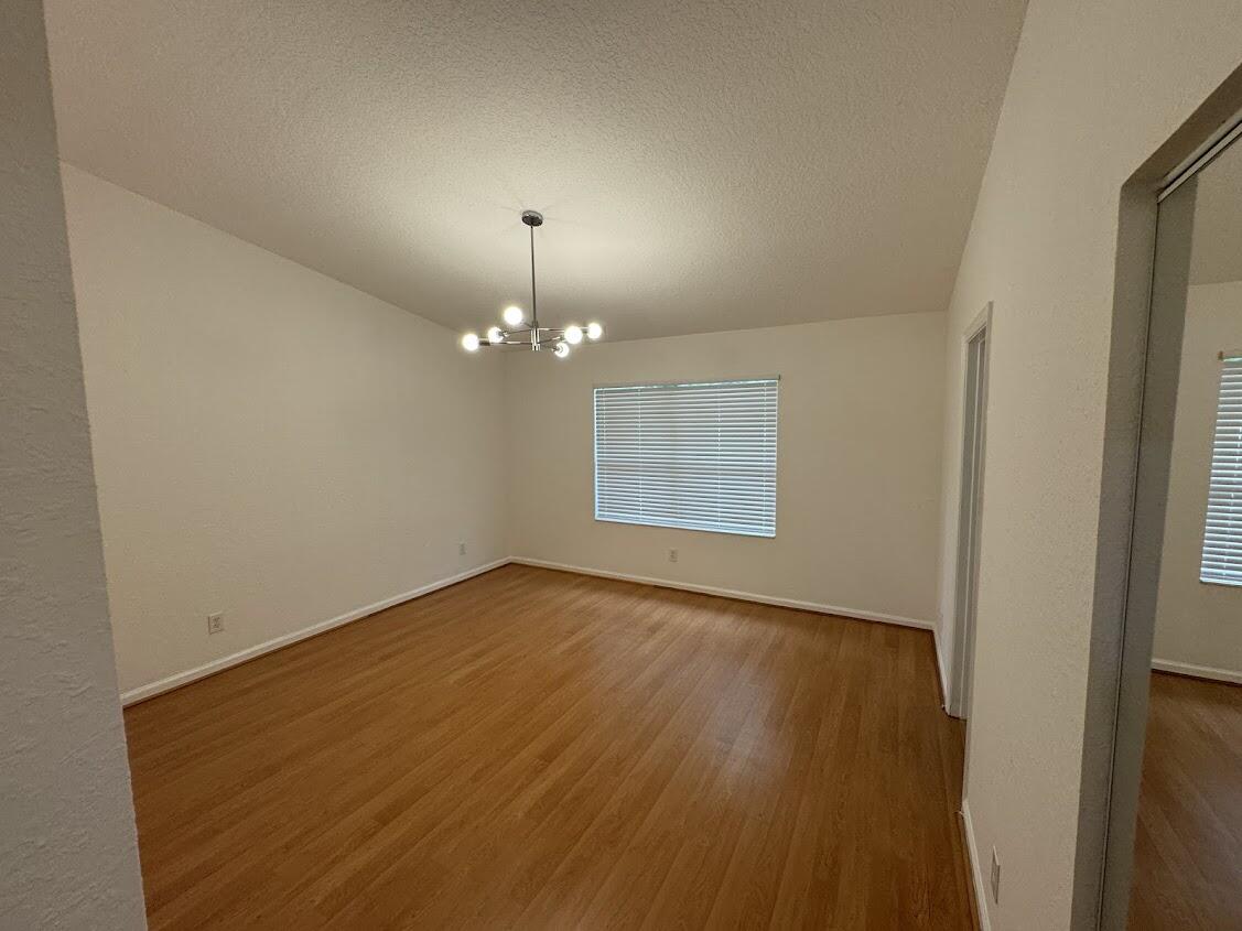 18237 Boca Way Drive Boca Raton, FL 33498 - Photo 19 of 36 wooden floor in an empty room with a window