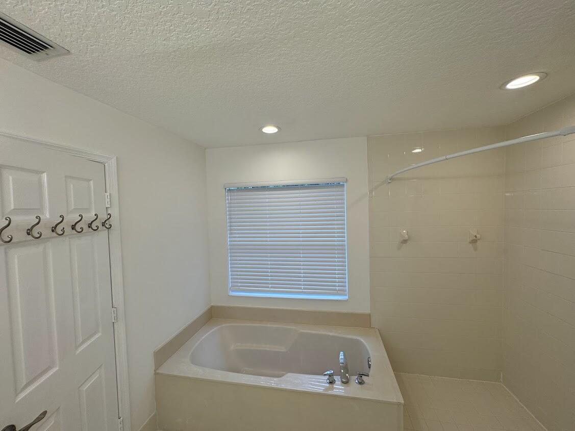 18237 Boca Way Drive Boca Raton, FL 33498 - Photo 26 of 36 a bath tub sitting in a bathroom next to a window