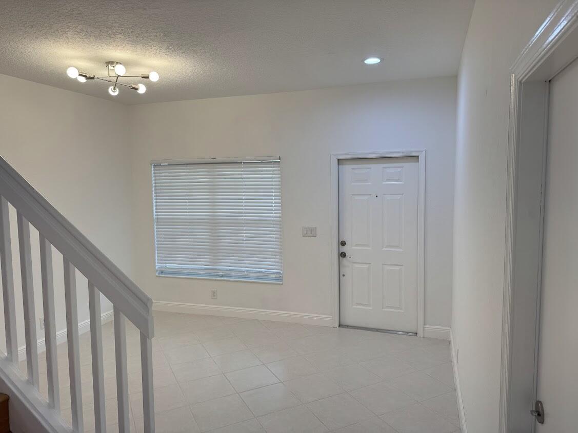 18237 Boca Way Drive Boca Raton, FL 33498 - Photo 4 of 36 a view of an empty room with a chandelier fan