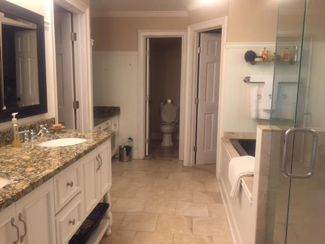 7798 Zebulon Road, Unit 1A Macon, GA 31220 - Photo 11 of 14 a bathroom with a granite countertop sink a mirror and shower
