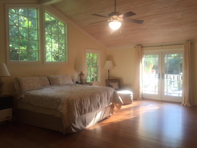 7798 Zebulon Road, Unit 1A Macon, GA 31220 - Photo 14 of 14 a spacious bedroom with a large bed and a chandelier