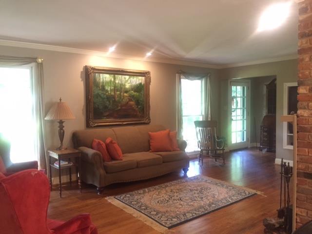 7798 Zebulon Road, Unit 1A Macon, GA 31220 - Photo 7 of 14 a living room with furniture rug and window