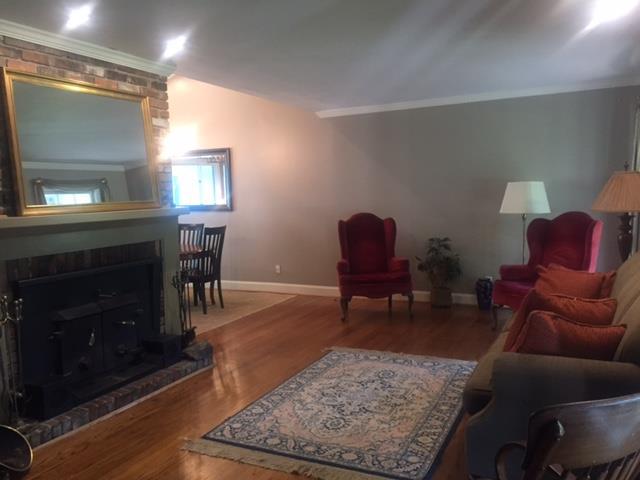 7798 Zebulon Road, Unit 1A Macon, GA 31220 - Photo 8 of 14 a living room with furniture a window and a fireplace