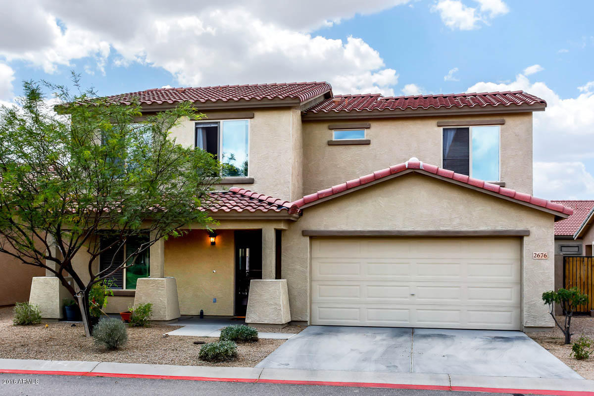 2676 South De Soto Road Apache Junction, AZ 85119 - Photo 1 of 19 a front view of a house with a garden