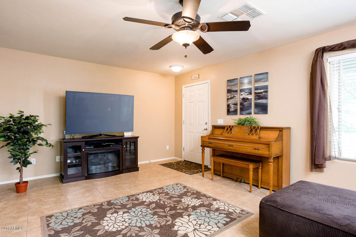 2676 South De Soto Road Apache Junction, AZ 85119 - Photo 3 of 19 a living room with furniture and a flat screen tv