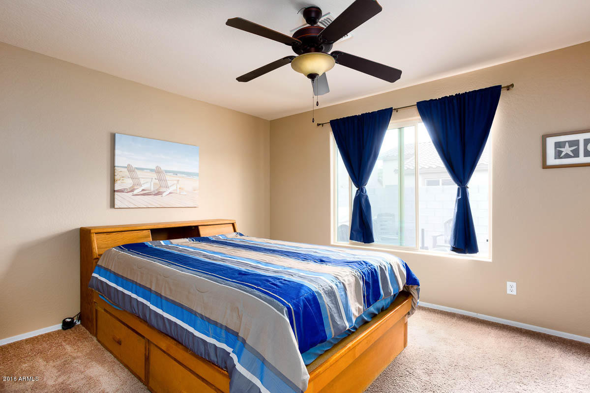 2676 South De Soto Road Apache Junction, AZ 85119 - Photo 7 of 19 a bedroom with a bed and a window