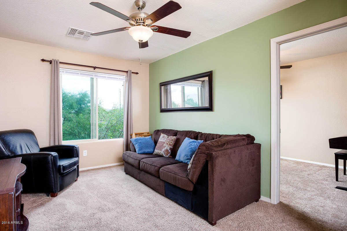 2676 South De Soto Road Apache Junction, AZ 85119 - Photo 9 of 19 a living room with furniture and a window