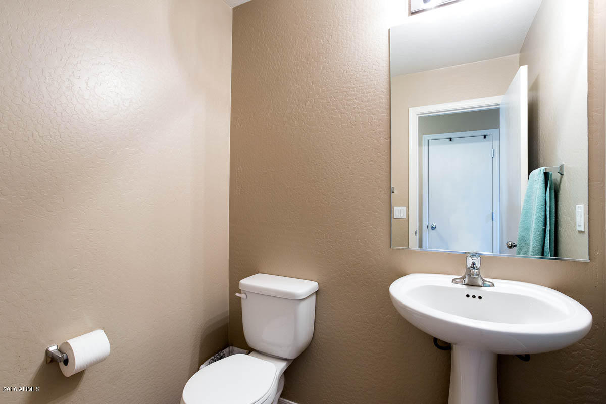2676 South De Soto Road Apache Junction, AZ 85119 - Photo 10 of 19 a bathroom with a sink a toilet and mirror