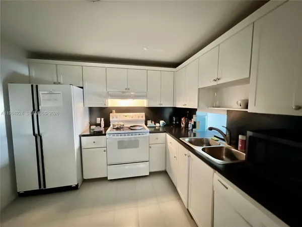 a kitchen with a refrigerator stove and sink