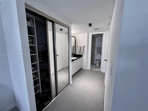 a view of hallway with walk in closet and stairs