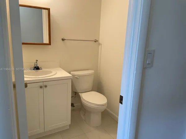 a white toilet sitting next to a bathroom sink