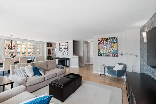 a living room with furniture wooden floor and a flat screen tv