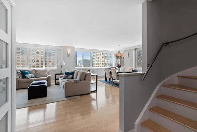 a living room with furniture and a floor to ceiling window