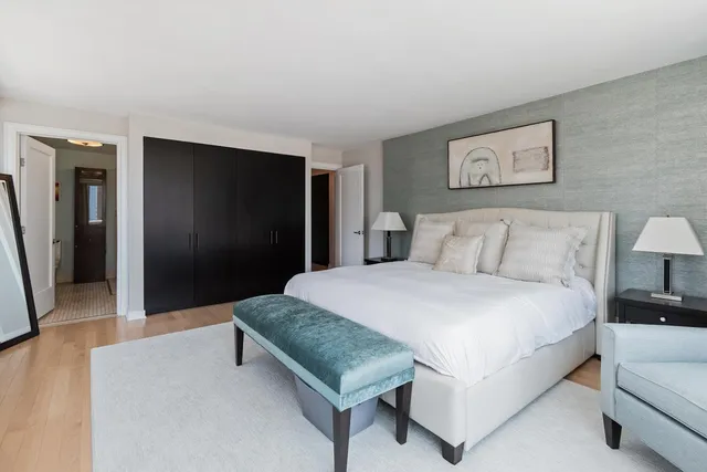 a spacious bedroom with a bed and a couch