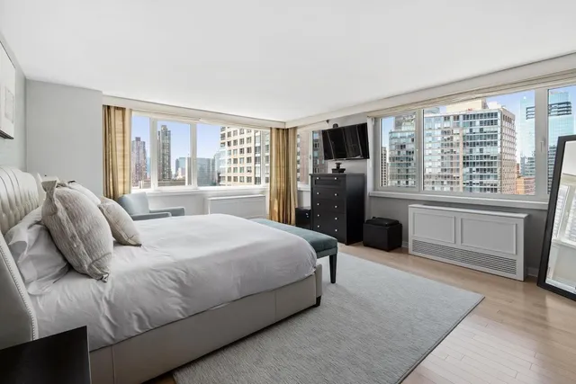 a bedroom with a large bed and a large window