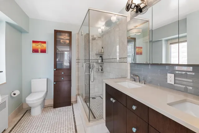 a spacious bathroom with a sink a toilet and shower