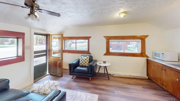 a living room with furniture and a wooden floor