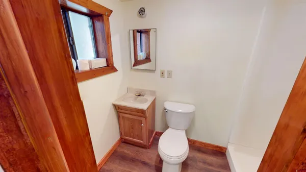 a white toilet sitting next to a sink and a mirror