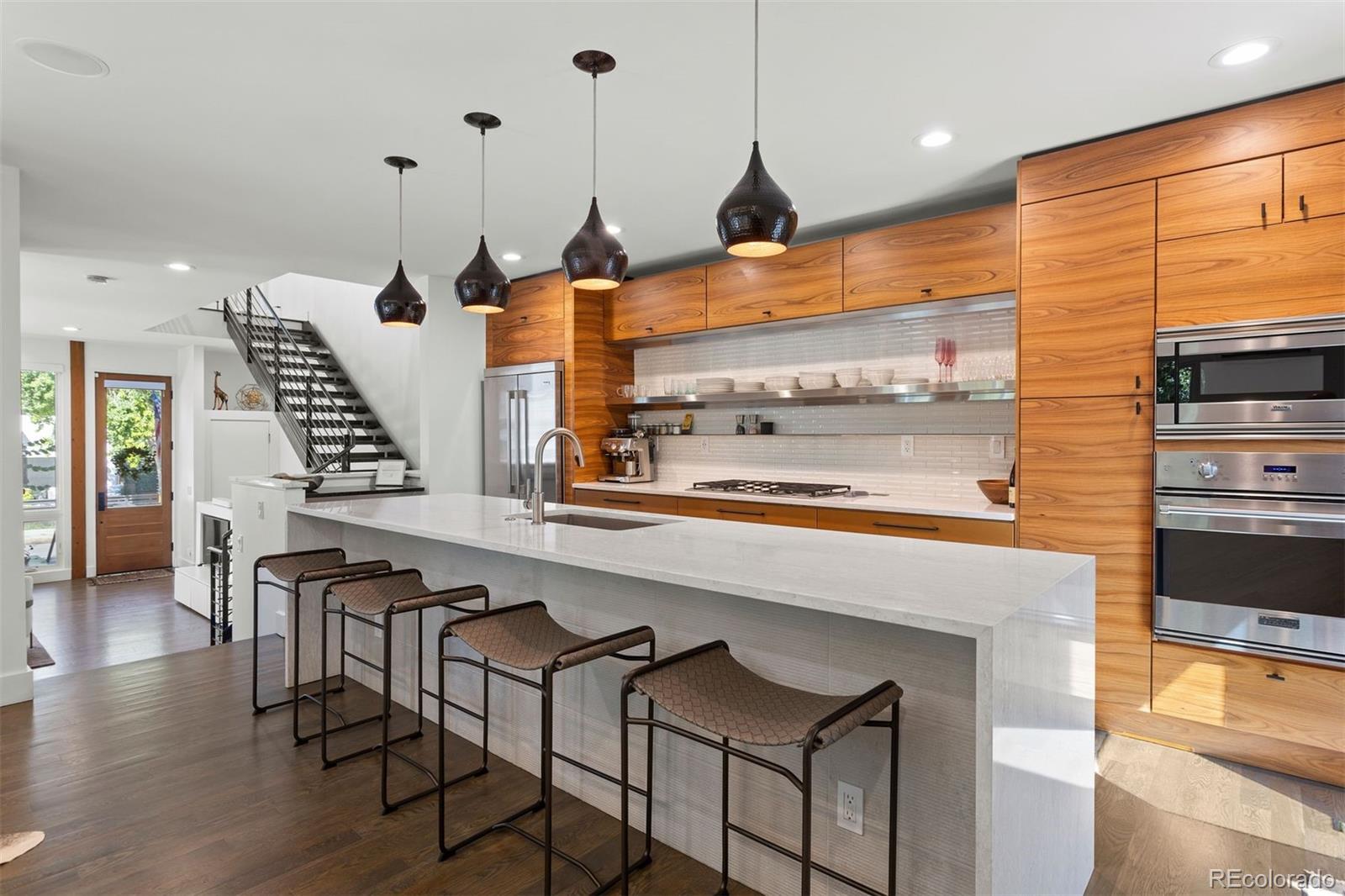 3400 Tejon Street Denver, CO 80211 - Photo 7 of 43 a kitchen with stainless steel appliances kitchen island granite countertop a stove and a view of living room