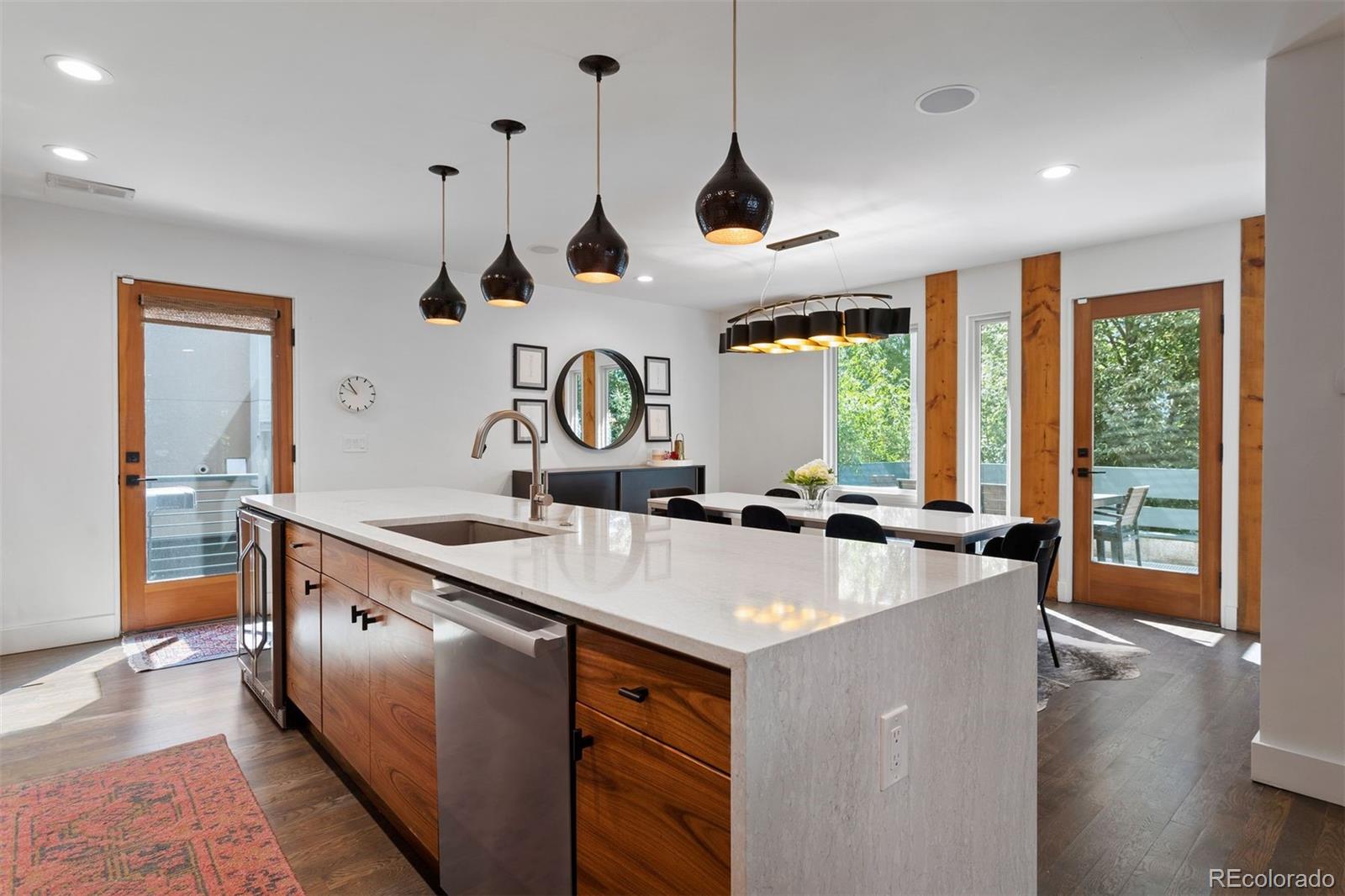 3400 Tejon Street Denver, CO 80211 - Photo 9 of 43 a kitchen with stainless steel appliances granite countertop a sink a stove and a wooden floors