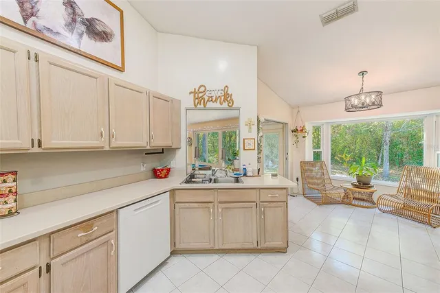 a kitchen with stainless steel appliances granite countertop a stove a sink and white cabinets
