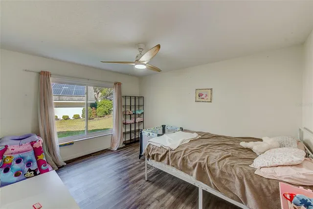 a bed room with a bed and a chair