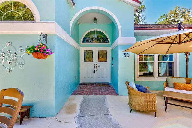 a backyard of a house with barbeque oven table and chairs