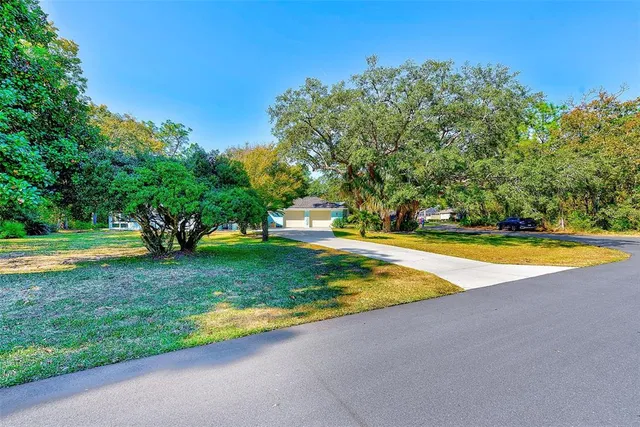 a view of a house with swimming pool and a garden