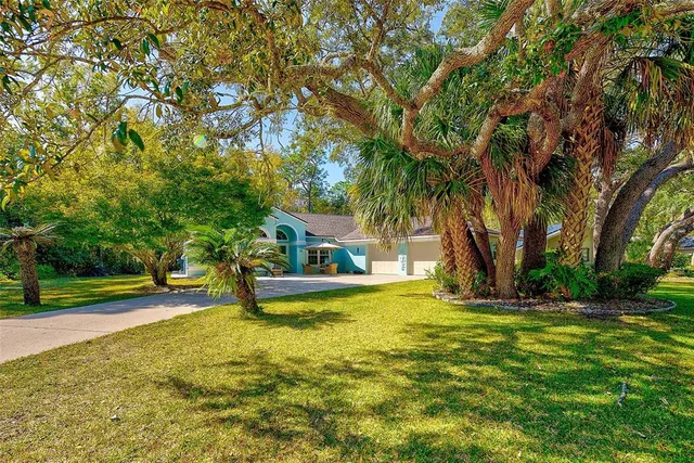 a view of a house with backyard and sitting area