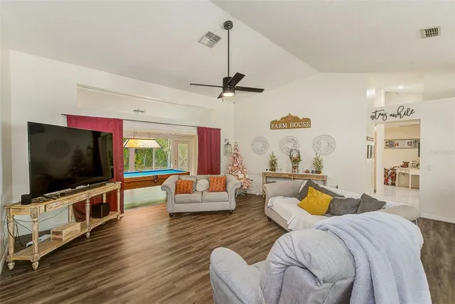 a bedroom with furniture and a flat screen tv