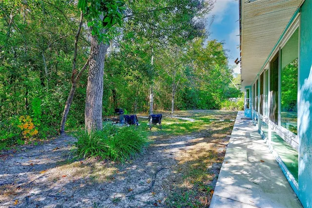 a view of house with backyard and garden