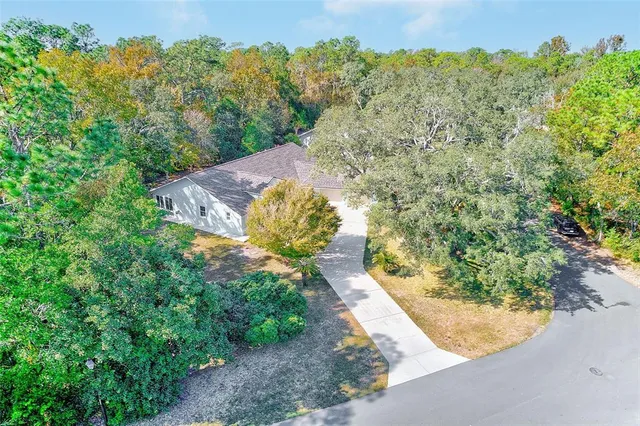 an aerial view of a house with a yard and garden