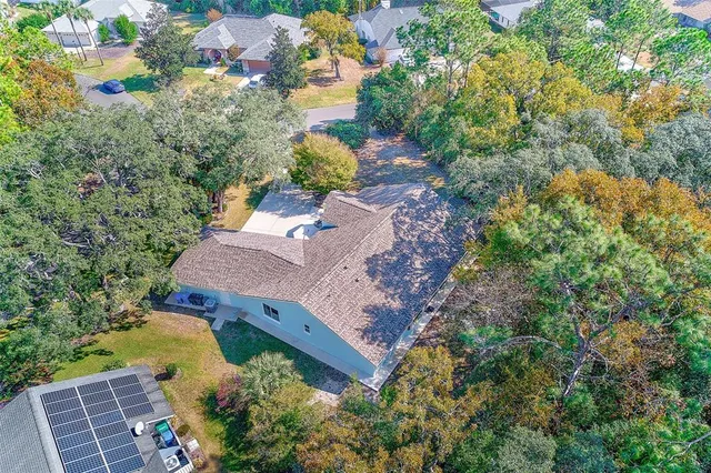 an aerial view of a house with a swimming pool yard and lake view